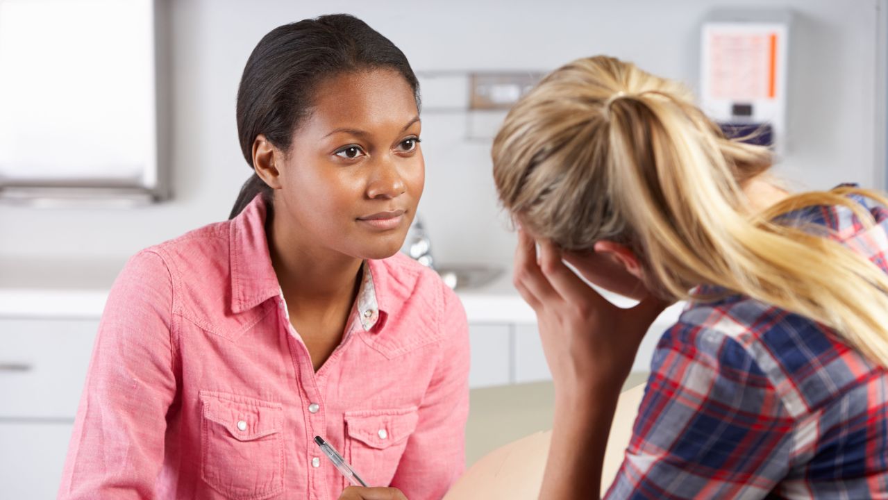 A therapy session occurring between 2 women