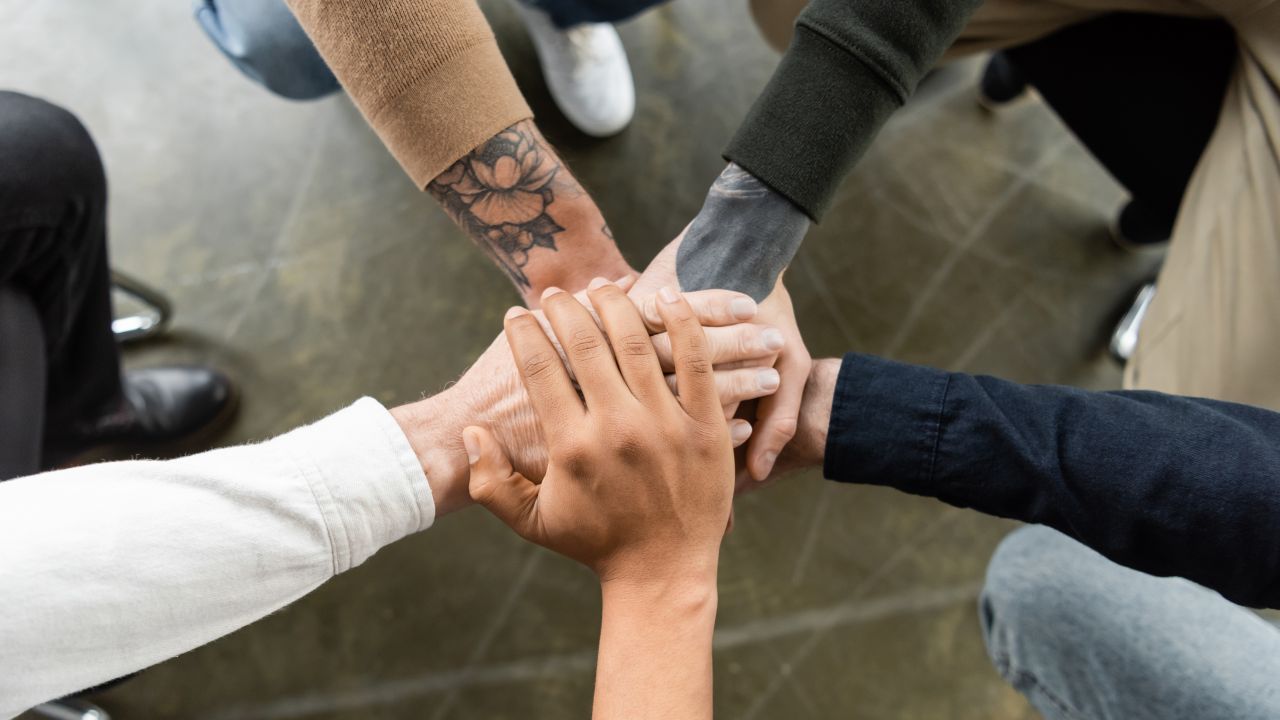 A group of hands clasped together